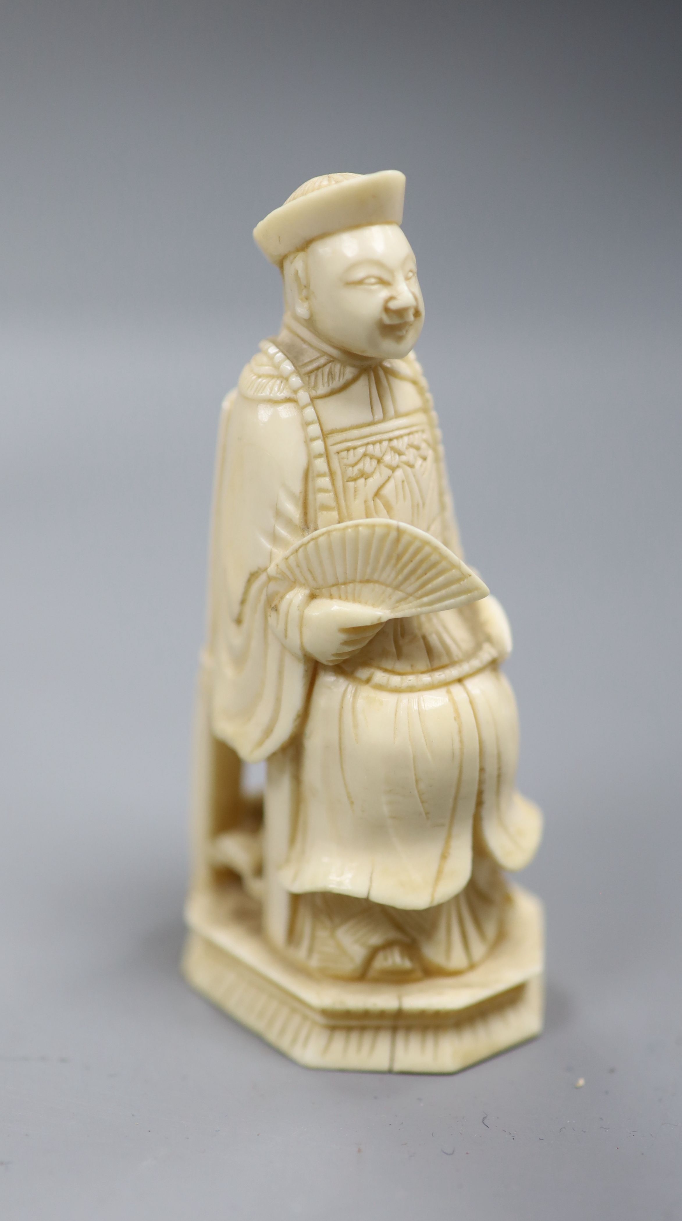 Three Chinese articulated ivory models of acrobats, two chess pieces, an ivory brush handle and needlework items